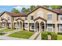 Inviting townhouse exterior featuring a terracotta roof and well-maintained landscaping at 6007 Scotchwood Gln # 37, Orlando, FL 32822