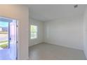 Bright, sunlit room with neutral tile flooring, offering a versatile space for various uses at 6230 Shavasana Rd, Clermont, FL 34714