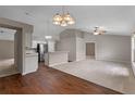 Open-concept living room featuring vaulted ceilings, wood floors, and neutral paint colors at 763 Via Milano, Apopka, FL 32712