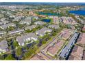 An aerial view highlights the community's layout, pools, and proximity to lakes at 8276 Maritime Flag St # 110, Windermere, FL 34786