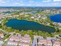 Aerial view of a lakefront community featuring lush landscaping and recreational facilities at 8276 Maritime Flag St # 110, Windermere, FL 34786