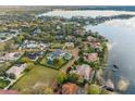 Stunning aerial view showcases waterfront homes, lush greenery, and the serene beauty of the adjacent lake at 9224 Bentley Park Cir, Orlando, FL 32819