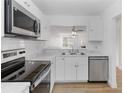 Bright kitchen featuring white cabinets, stainless steel appliances, and an open layout at 9516 Darien Ave # 9516, Orlando, FL 32817