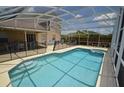 Inviting screened-in pool with a connected spa, surrounded by ample patio space and comfortable seating at 954 Lockbreeze Dr, Davenport, FL 33897