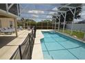 Screened-in pool and spa area, offering a relaxing outdoor space with comfortable lounge chairs at 954 Lockbreeze Dr, Davenport, FL 33897