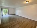 The living room has hard wood floors and a glass sliding door that leads to the outside at 101 Scottsdale Sq # 101, Winter Park, FL 32792