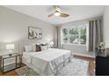 Bright bedroom with wood floors, a large window, and neutral decor at 11866 Barletta Dr, Orlando, FL 32827