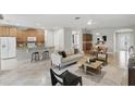 Spacious living room with a modern kitchen, dining area, and comfortable seating at 11866 Barletta Dr, Orlando, FL 32827