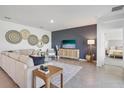 Bright living room featuring stylish decor, a large sectional, and a modern entertainment center at 1507 Fountain View St, Ormond Beach, FL 32174