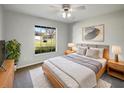 Bright bedroom with large window, contemporary decor, and a ceiling fan at 15525 Seymour Ln, Groveland, FL 34736