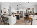 Open kitchen featuring stainless steel appliances, granite countertops, an island, and a cozy breakfast nook at 1613 Glenwick Dr, Windermere, FL 34786