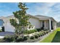 Well-maintained home exterior featuring manicured landscaping, a brick driveway, and a welcoming entrance at 17667 Saw Palmetto, Clermont, FL 34714