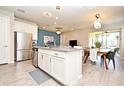 Open-concept kitchen featuring a center island, stainless steel appliances, and seamless flow to the dining area at 17667 Saw Palmetto, Clermont, FL 34714