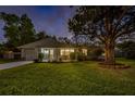 Charming single-story home at dusk, featuring a well-manicured lawn and inviting curb appeal at 1832 Magnolia Ave, Winter Park, FL 32789