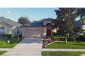 A cozy single-Gathering home with well-maintained landscaping and a two-car garage at 1862 Great Falls Way, Orlando, FL 32824
