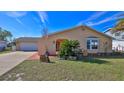 Single-story home with attached garage, landscaping, and a well-maintained lawn at 209 Georgetowne Blvd, Daytona Beach, FL 32119