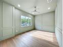 Light-filled bedroom with custom paneling, ceiling fan, and large window at 3206 Harrison Ave, Orlando, FL 32804