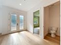 Elegant foyer with hardwood floors, powder room, and a view of living area at 3206 Harrison Ave, Orlando, FL 32804