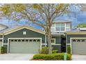 Inviting townhome featuring a gray exterior, a two-car garage, and manicured landscaping at 346 Canyon Stone Cir, Lake Mary, FL 32746