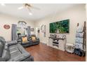Cozy living room with hardwood floors, a large TV, and comfortable seating, perfect for Gathering gatherings at 37 Spring Ln, Haines City, FL 33844
