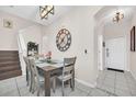 Dining area featuring a wooden table, seating for six, and a decorative wall clock at 438 Miramar Ave, Davenport, FL 33897