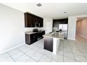 Kitchen with a large island, dark wood cabinets, and granite countertops at 464 Patricia Alford Dr, Haines City, FL 33844