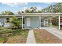 Inviting front entrance with covered carport, and well-manicured lawn at 5215 Ashwood Pl, Orlando, FL 32808
