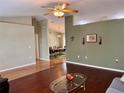 Spacious living room featuring hardwood floors and view of dining area at 5347 Pecan Rd, Ocala, FL 34472