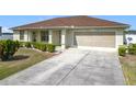 View of charming single story house with an attached two-car garage and a concrete driveway at 5361 Se 92Nd St, Ocala, FL 34480