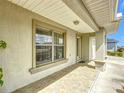 Covered front porch featuring tiled flooring, decorative columns, and a view of the front lawn at 5361 Se 92Nd St, Ocala, FL 34480
