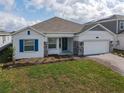 Charming single-Gathering home with a brick paver driveway, stone accents, and blue shutter at 5655 Stephens Rd, St Cloud, FL 34771