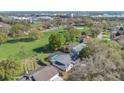 Aerial shot of the home's location on a golf course, backing to mature trees, and a screened pool at 6735 Edgeworth Dr, Orlando, FL 32819