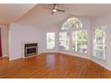 Bright living room with hardwood floors, fireplace, and ample natural light from large windows at 675 Youngstown Pkwy # 258, Altamonte Springs, FL 32714