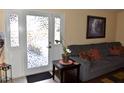 Living room showcasing decorative glass doors, neutral colored sofa, and tasteful decor for a cozy space at 7508 Covedale Dr, Orlando, FL 32818