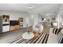 Open-concept living room featuring stylish furniture and wood flooring throughout at 759 Dromedary Dr, Kissimmee, FL 34759