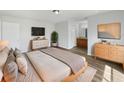 Serene main bedroom featuring hardwood floors, ensuite bath, and contemporary furnishings at 759 Dromedary Dr, Kissimmee, FL 34759