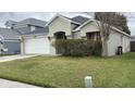 Charming single-Gathering home features a two-car garage, well-maintained landscaping, and a welcoming front entrance at 8419 Fort Thomas Way, Orlando, FL 32822