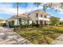 An exterior front view of a two-story home featuring a well-manicured lawn and three-car garage at 8661 Crestgate Cir, Orlando, FL 32819