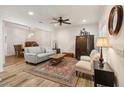 Bright living room with stylish decor, ceiling fan, and wood-look floors at 9686 Cypress Pine St, Orlando, FL 32827