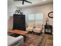 Relaxing area with modern furniture, hardwood floors and a rustic cabinet at 9686 Cypress Pine St, Orlando, FL 32827