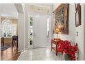 Inviting entryway with a decorative rug, tiled floors, and a bright front door at 12018 Radbourne St, Winter Garden, FL 34787