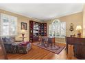 Cozy living room with hardwood floors, a plush chair, and a built-in bookcase at 12018 Radbourne St, Winter Garden, FL 34787