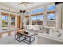 Bright living room with large windows, hardwood floors, and modern furniture at 12848 Jacob Grace Ct, Windermere, FL 34786