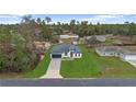 An elevated view of a cozy single-Gathering home with a lush green lawn in a tranquil neighborhood at 16659 Sw 21St Avenue Rd, Ocala, FL 34473