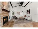 Spacious living room featuring a stone fireplace, high ceilings and a ceiling fan at 178 W Sabal Palm Pl # 62, Longwood, FL 32779