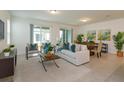 Bright and airy living room with tile floors, slider door, and a dining area for seamless entertaining at 2472 Firstlight Way, Winter Park, FL 32792