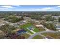 An aerial view of a single Gathering home surrounded by lush greenery and neighboring houses at 2480 Sw 147Th Lane Rd, Ocala, FL 34473