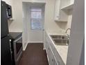 Well-lit kitchen with modern appliances, white cabinets, and ample counter space at 2727 W Oak Ridge Rd # 5-6, Orlando, FL 32809
