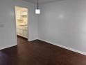 Open concept living room with wood flooring and views of the kitchen at 2727 W Oak Ridge Rd # 5-6, Orlando, FL 32809