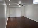 Spacious living room featuring hardwood floors, ceiling fan, and sliding glass doors at 2727 W Oak Ridge Rd # 5-6, Orlando, FL 32809